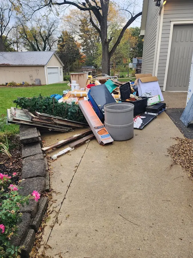 Dumpster being loaded with debris for Estate Cleanout Dumpster Rental in River Oaks